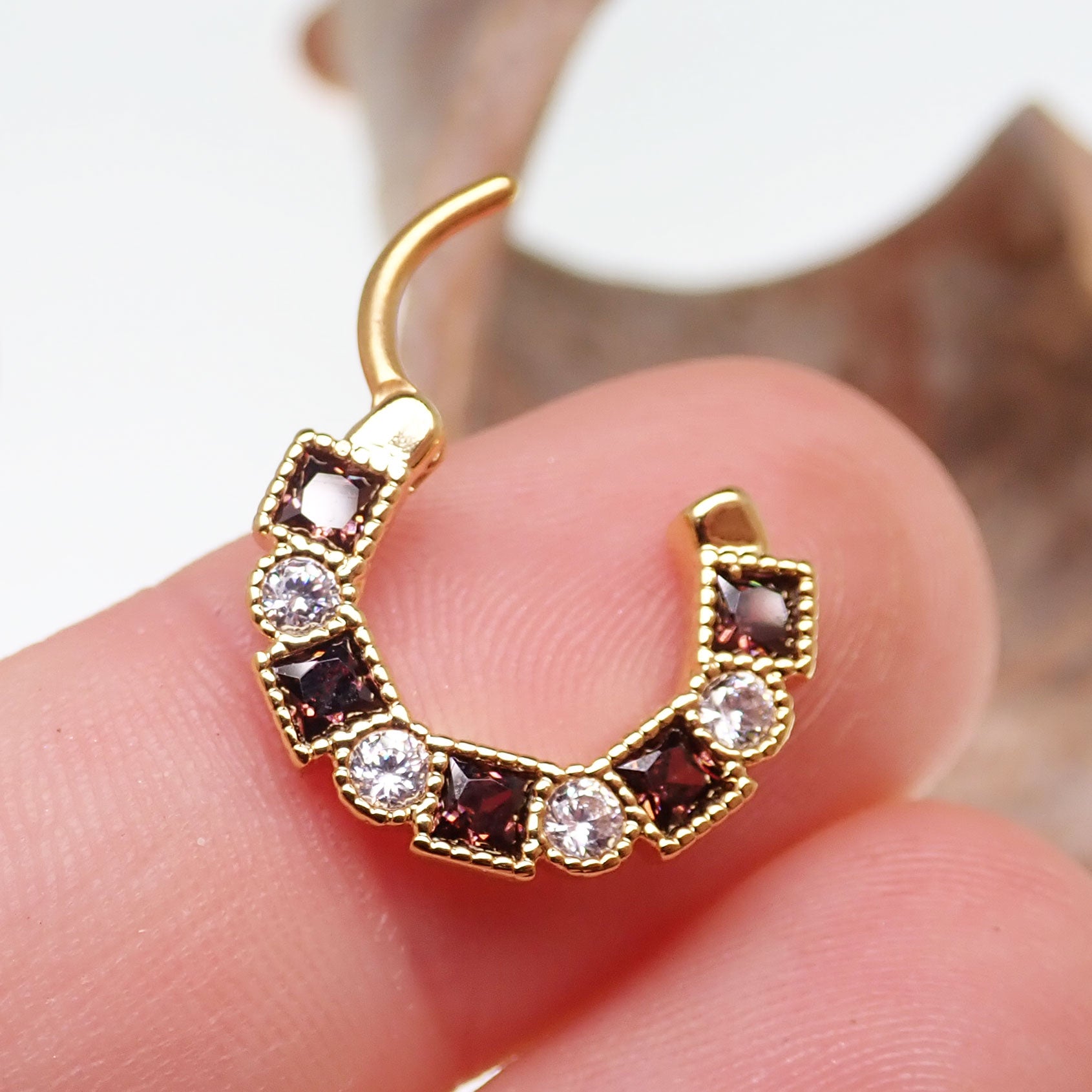 Steel clicker body jewelry with amber and clear CZ stones, 16g, featuring a sleek design and sparkling gemstone accents.