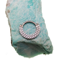 Steel double-row CZ inlaid clicker body jewelry in 16g with a sleek design and sparkling gemstone accents.