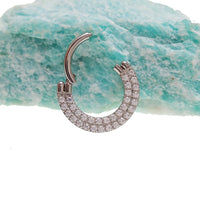 Steel double-row CZ inlaid clicker body jewelry in 16g with sleek design and sparkling cubic zirconia accents.