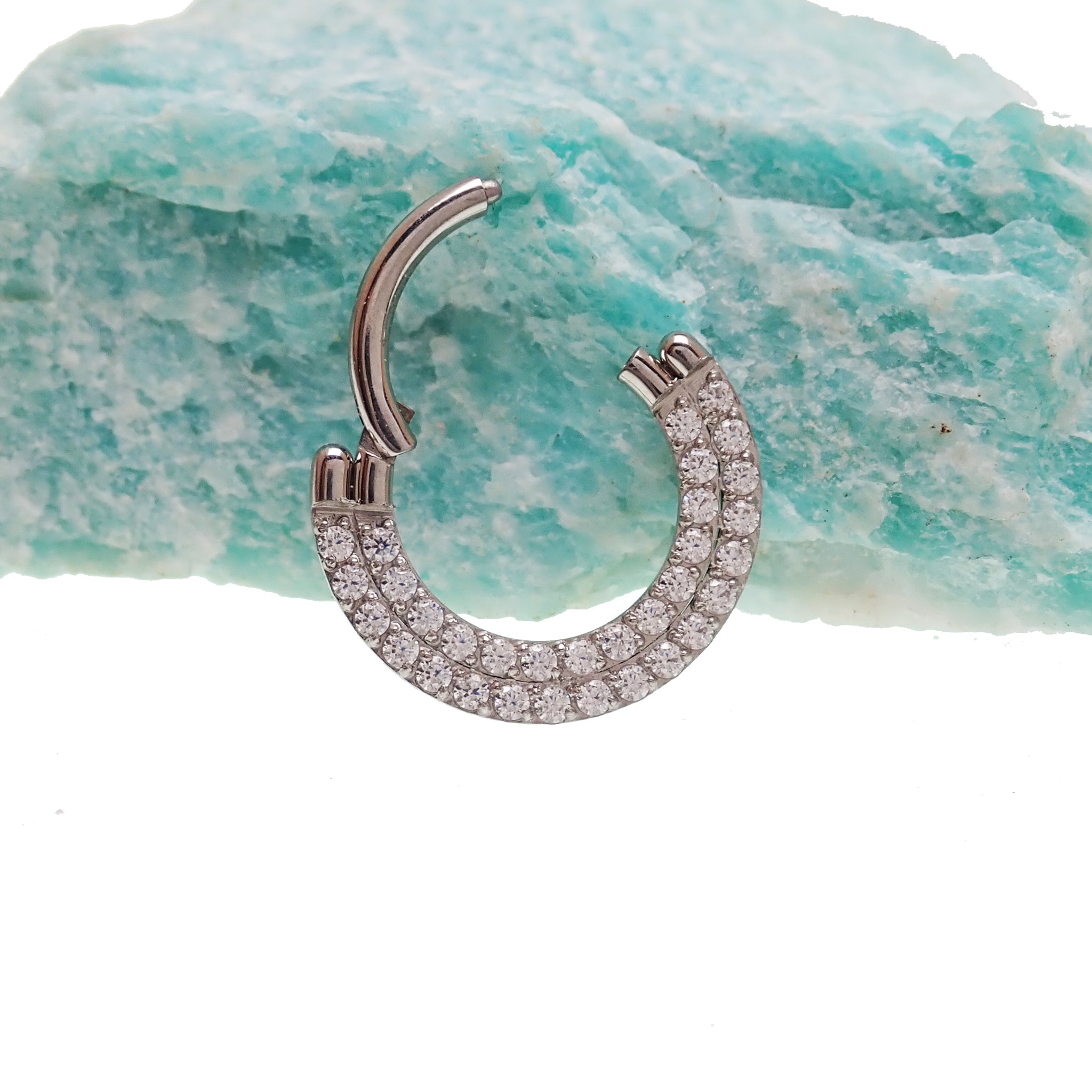 Steel double-row CZ inlaid clicker body jewelry in 16g with sleek design and sparkling cubic zirconia accents.