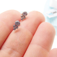 Titanium cluster earrings by Body Clickers Body Jewelry featuring multiple linked titanium beads and a secure hook closure.
