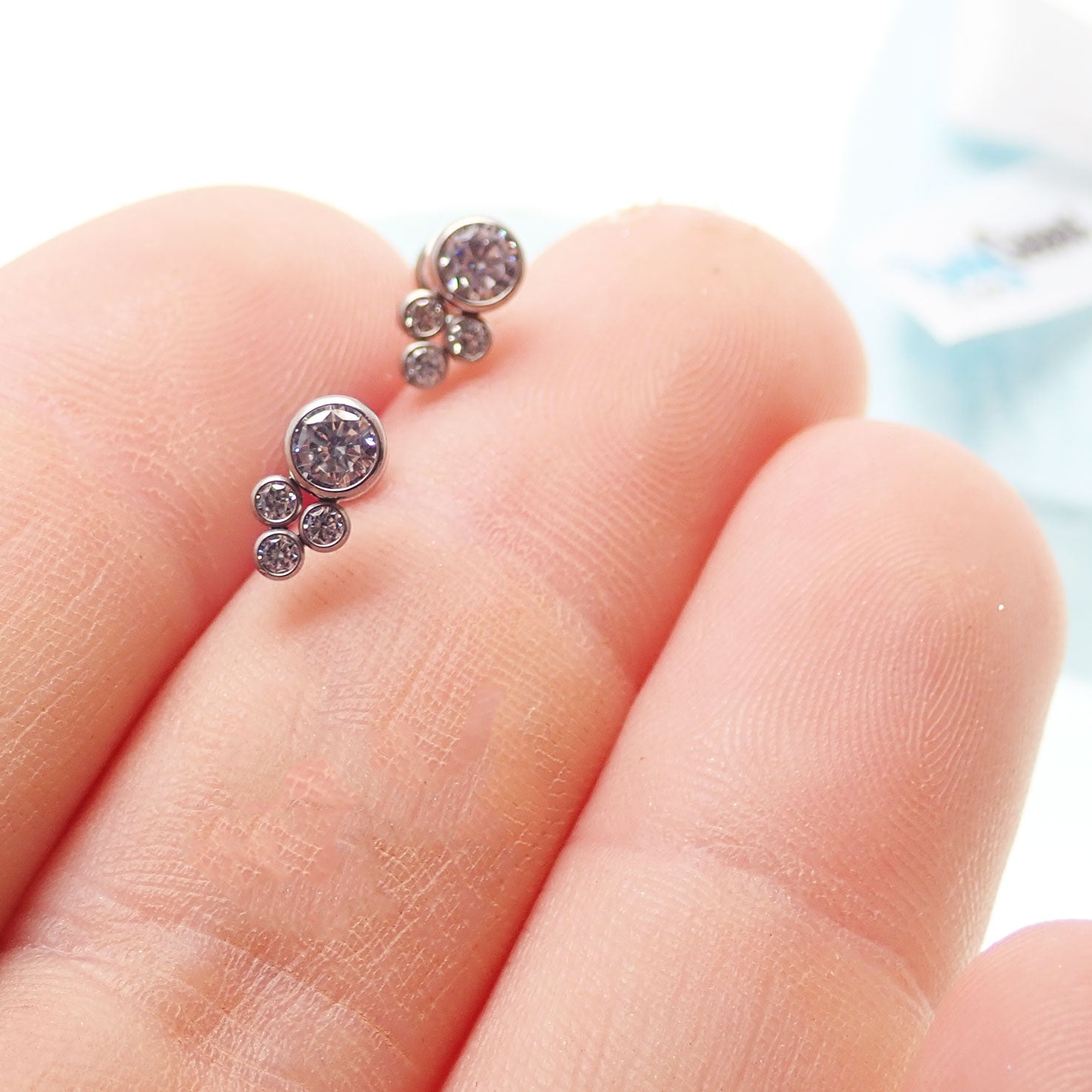 Titanium cluster earrings by Body Clickers Body Jewelry featuring multiple linked titanium beads and a secure hook closure.