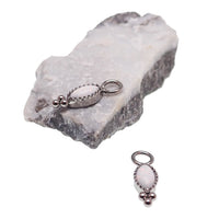 White opal oval beaded CZ charm for body jewelry by Body Clickers, showcasing intricate beaded design and sparkling cubic zirconia.