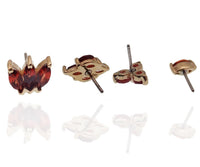 14K gold garnet threadless labret piercing with a flat back, featuring a natural red garnet stone for body jewelry.