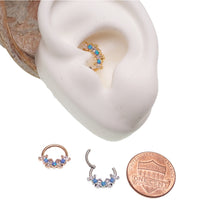 Blue opal and clear CZ surgical steel clicker body jewelry in 16g with gold accents, designed for body piercing.