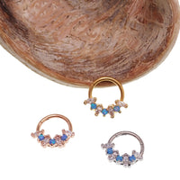 Blue Opal and clear CZ surgical steel clicker body jewelry in 16g with gold accents, designed for body piercing.