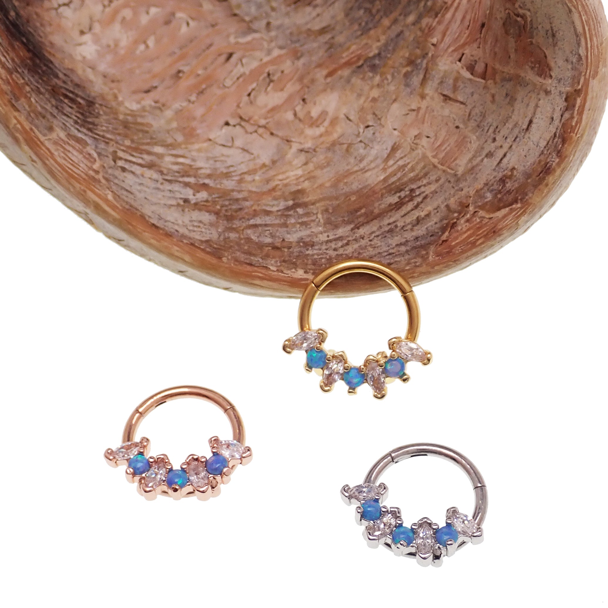Blue Opal and clear CZ surgical steel clicker body jewelry in 16g with gold accents, designed for body piercing.