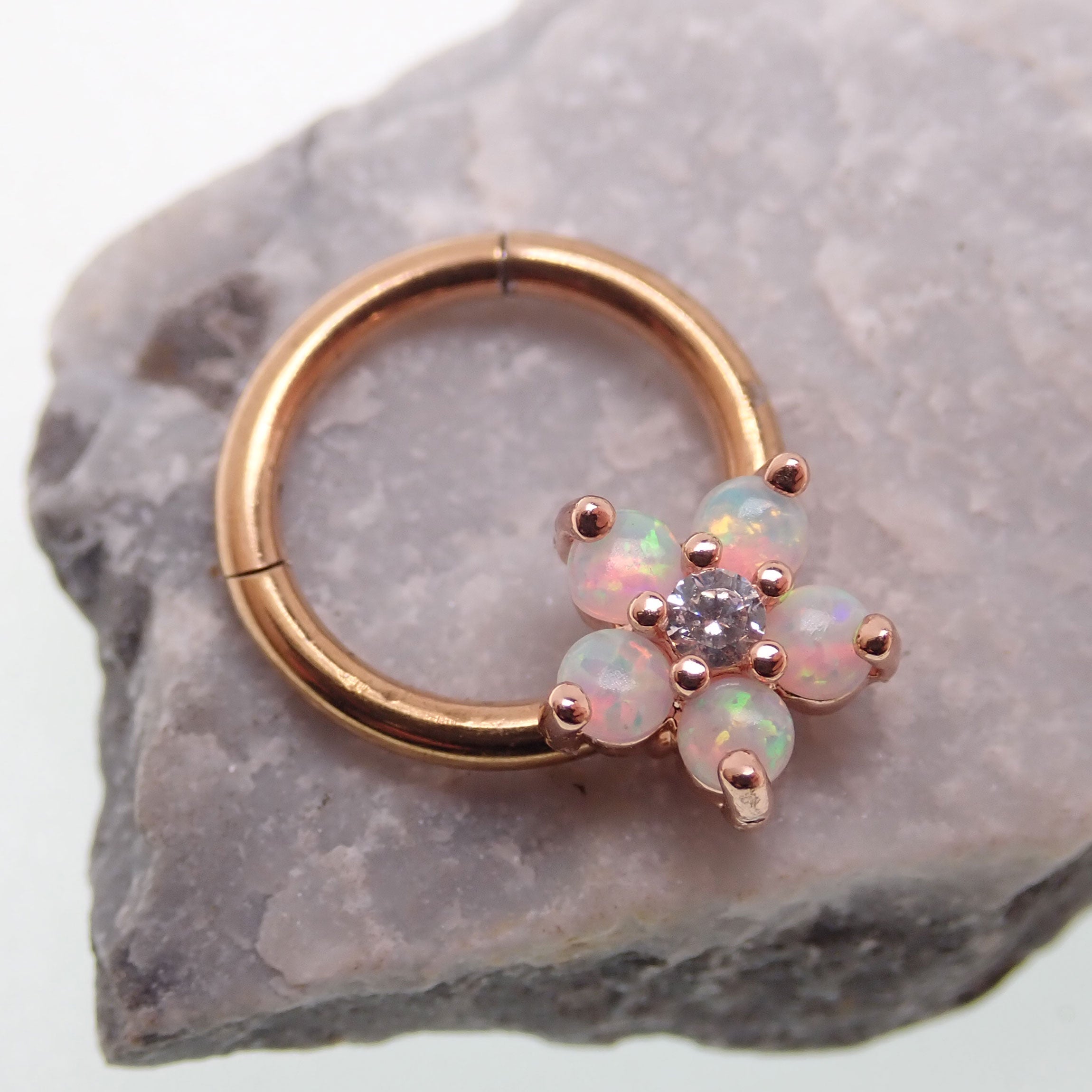 Gold flower opal clicker hoop with 8mm diameter and 16g body jewelry, featuring floral design and opal accents.