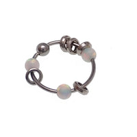 Steel body jewelry ring with assorted attachments, 22g, by Body Clickers, featuring a green 8mm steel ring with decorative elements.