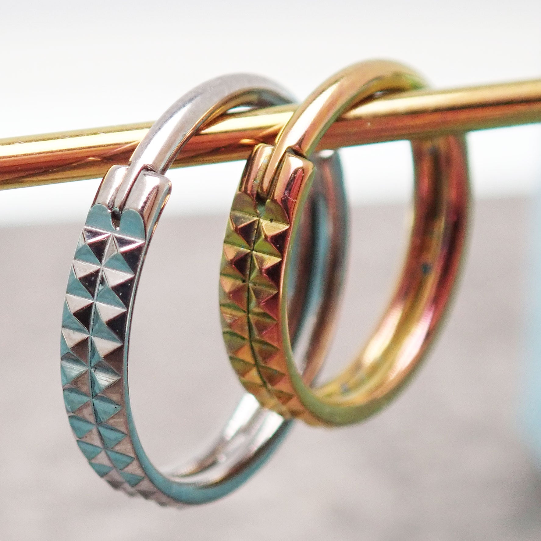 Hinged engraved double row clicker body jewelry in 16g with 8mm width, featuring detailed engraving and sleek design.
