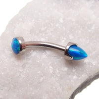 Yellow opal spike and cabochon curved barbell in 16g body jewelry by Body Clickers, with moon-shaped design and smooth finish.