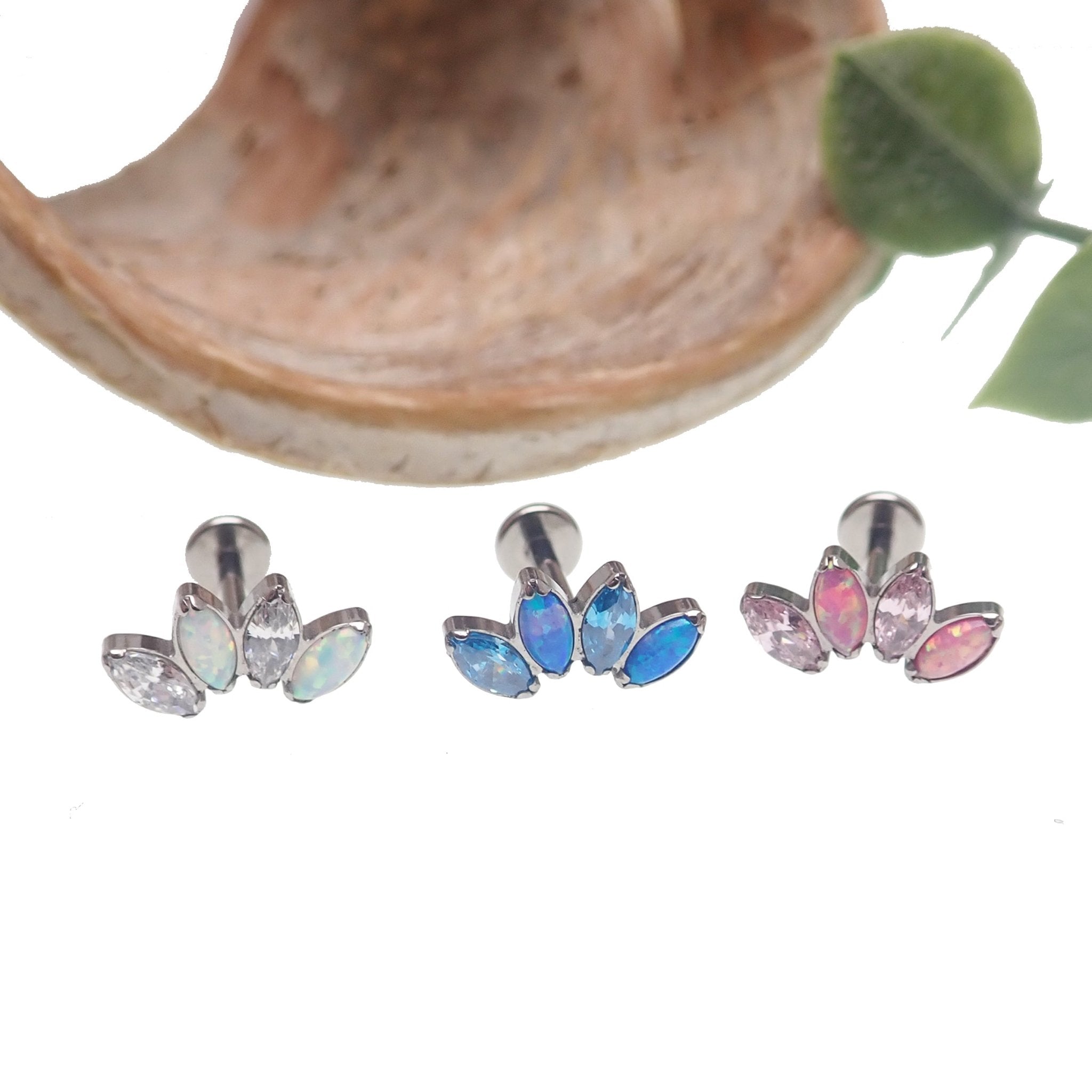 Opal and CZ 4-petal crown flatback labret body jewelry in 14g, 16g, and 18g from Body Clickers with Pacific Blue stones.