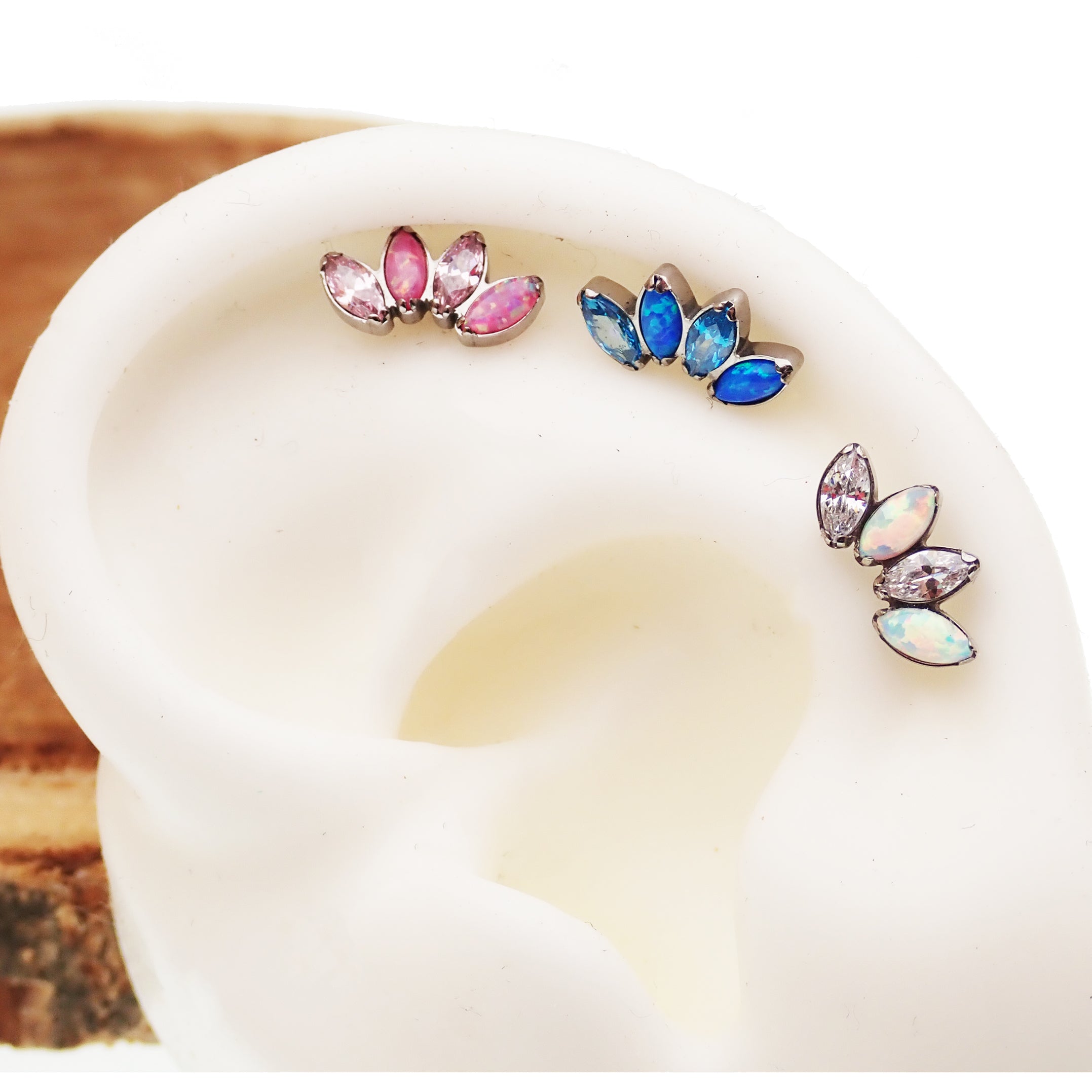 Opal and CZ 4-petal crown flatback labret body jewelry in 18g, 16g, or 14g with Pacific blue stones by Body Clickers.