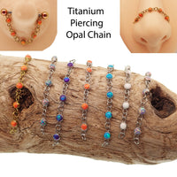 Titanium opal piercing add-on chain for body jewelry by Body Clickers, featuring peacock blue opal accents and sleek design.