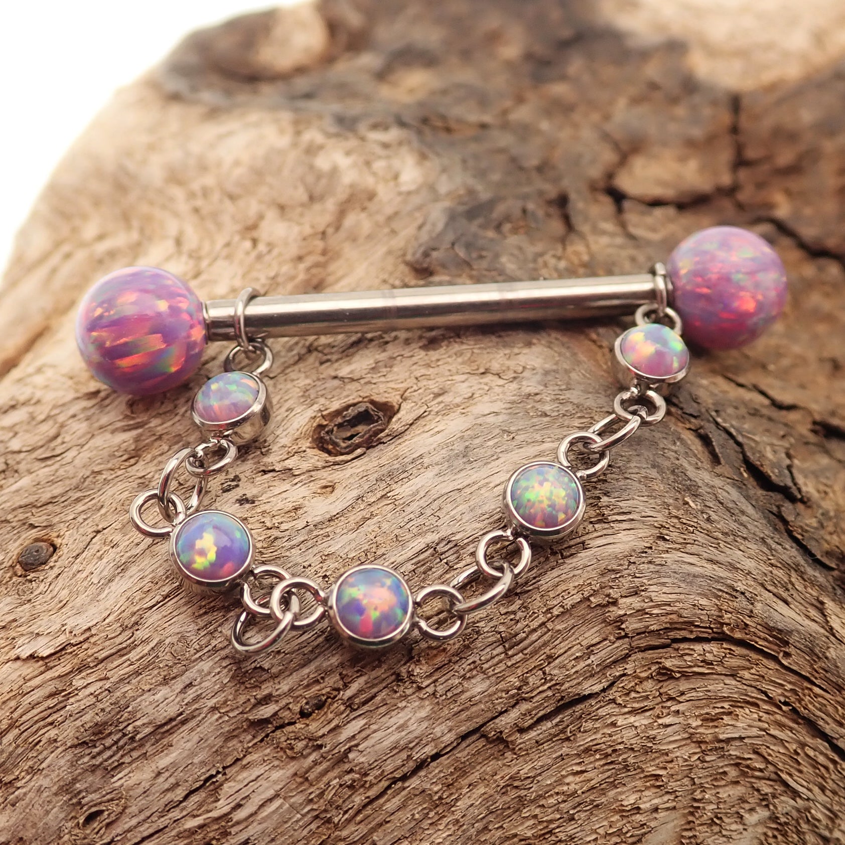 Titanium opal piercing add-on chain for body jewelry by Body Clickers, featuring a peacock blue opal and sleek chain design.