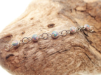 Titanium opal piercing add-on chain for body jewelry by Body Clickers, featuring peacock blue opal and sleek design.