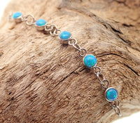Body Clickers titanium opal piercing add-on chain in peacock blue, body jewelry featuring vibrant gemstone and sleek design