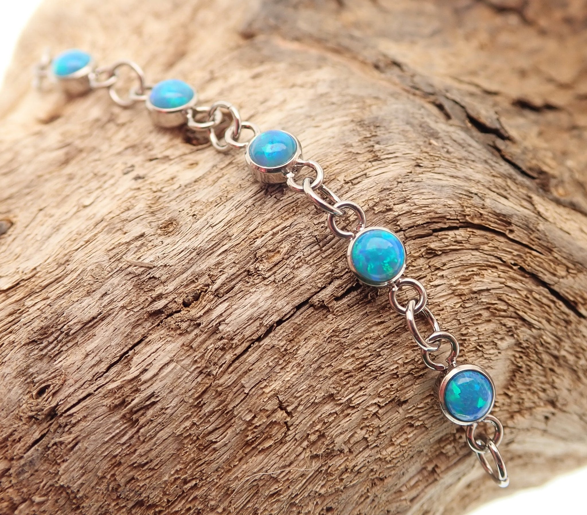 Body Clickers titanium opal piercing add-on chain in peacock blue, body jewelry featuring vibrant gemstone and sleek design
