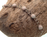 Titanium opal piercing add-on chain for body jewelry by Body Clickers, featuring peacock blue opal and sleek design.