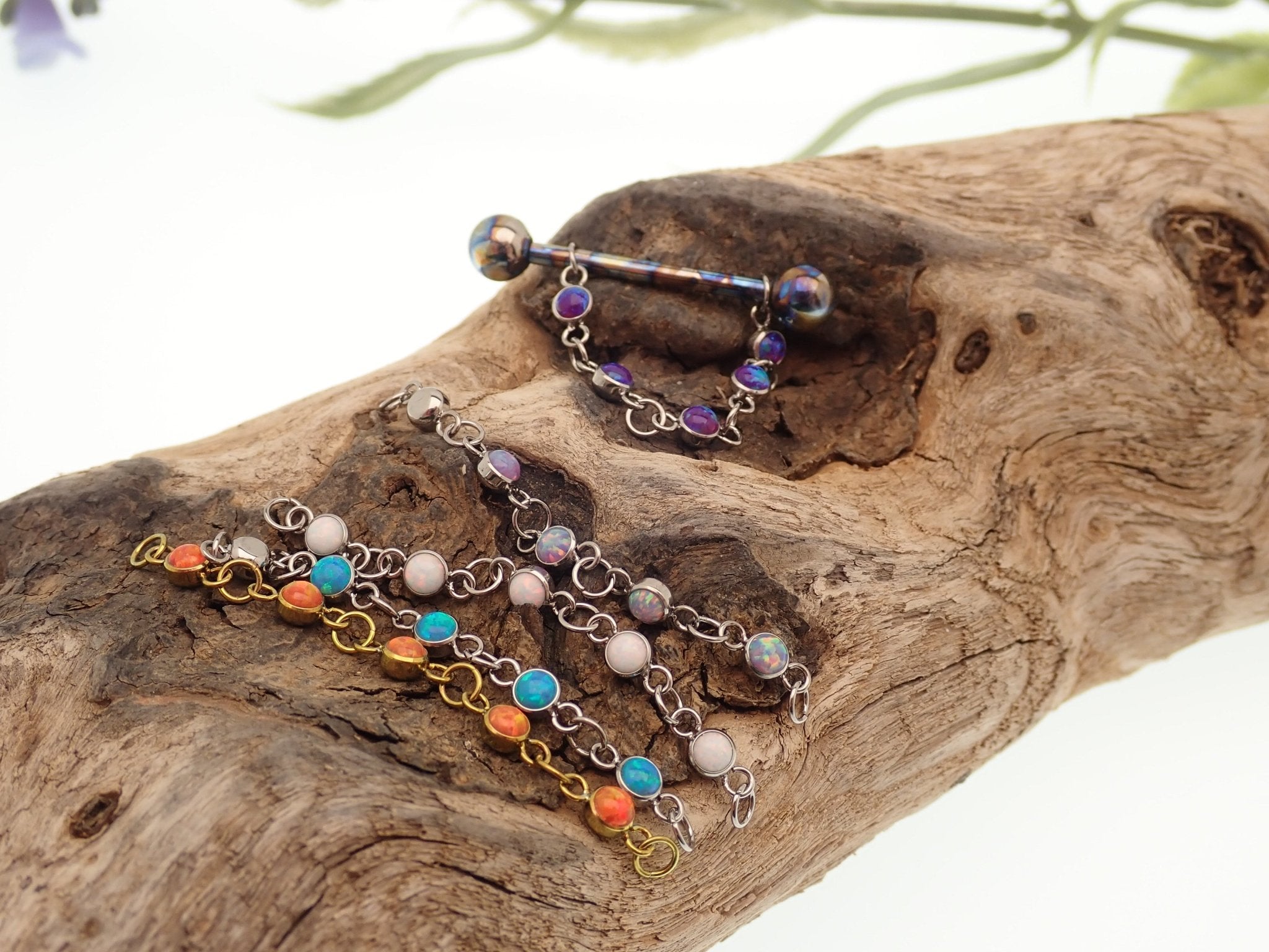 Titanium opal piercing add-on chain for body jewelry by Body Clickers, featuring peacock blue gemstone and delicate chain design.