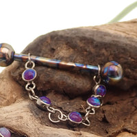 Titanium opal piercing add-on chain for body jewelry by Body Clickers, featuring peacock blue gemstone and intricate design.