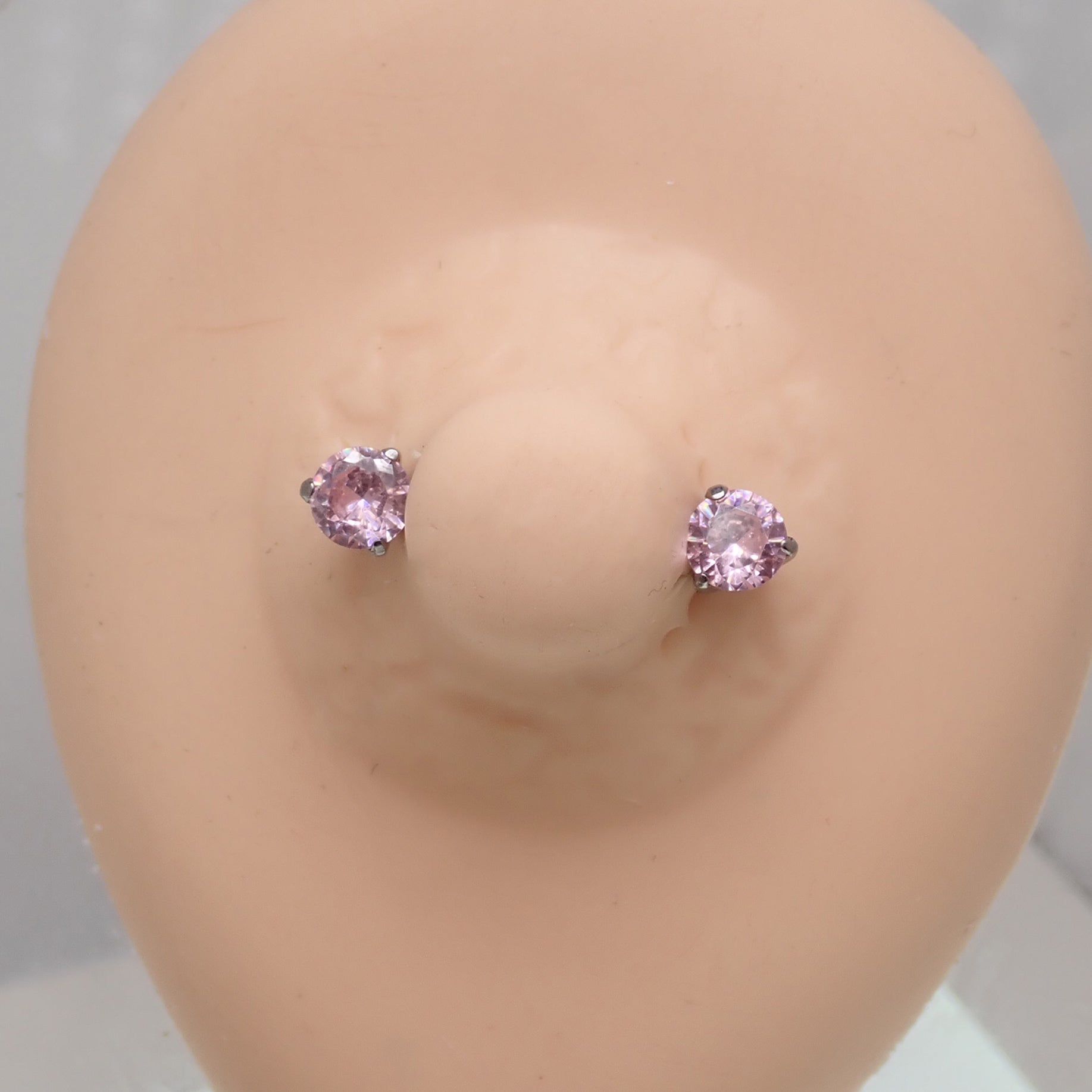 Pink CZ push fit threadless nipple bar in 12g, 14g, 16g body jewelry by Body Clickers displayed with various gauge sizes.