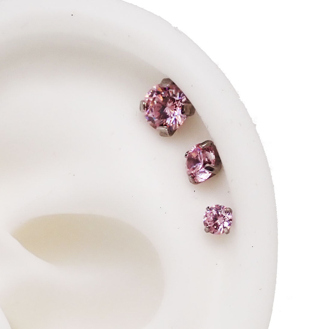 Set of three Body Clickers pink body jewelry with triple CZ flat back in 14g, 16g, and 18g sizes for body piercing.