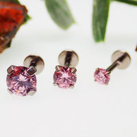 Set of three pink Body Clickers body jewelry with triple CZ stones in 14g, 16g, and 18g flat back designs.