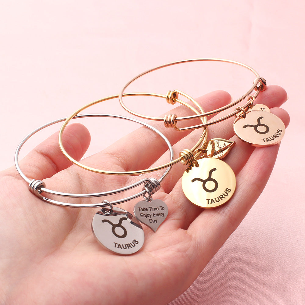 Silver Capricorn steel zodiac bangle by Body Clickers Body Jewelry, featuring a sleek design with zodiac symbol engraving.