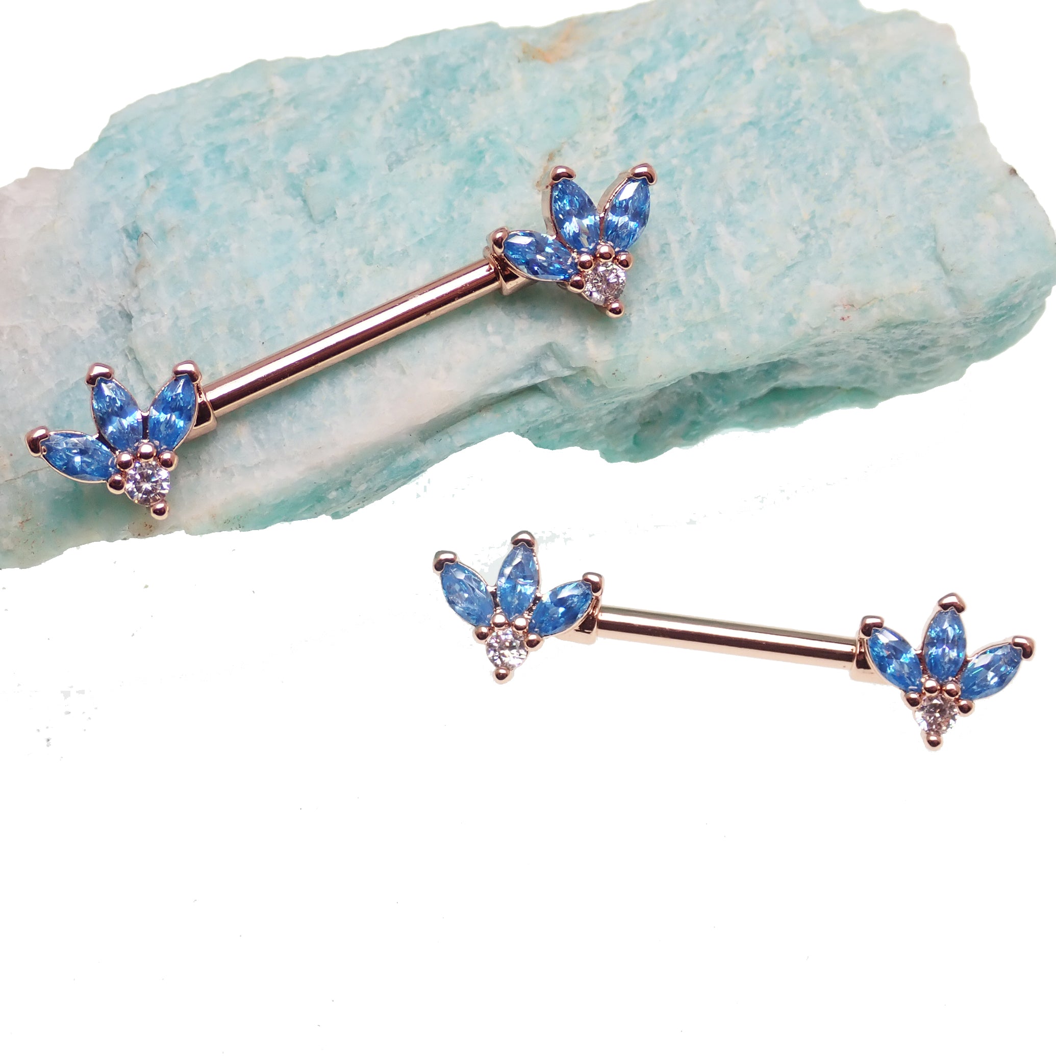 Blue and clear cubic zirconia rose gold flower steel nipple bar, 14g body jewelry with intricate floral design.