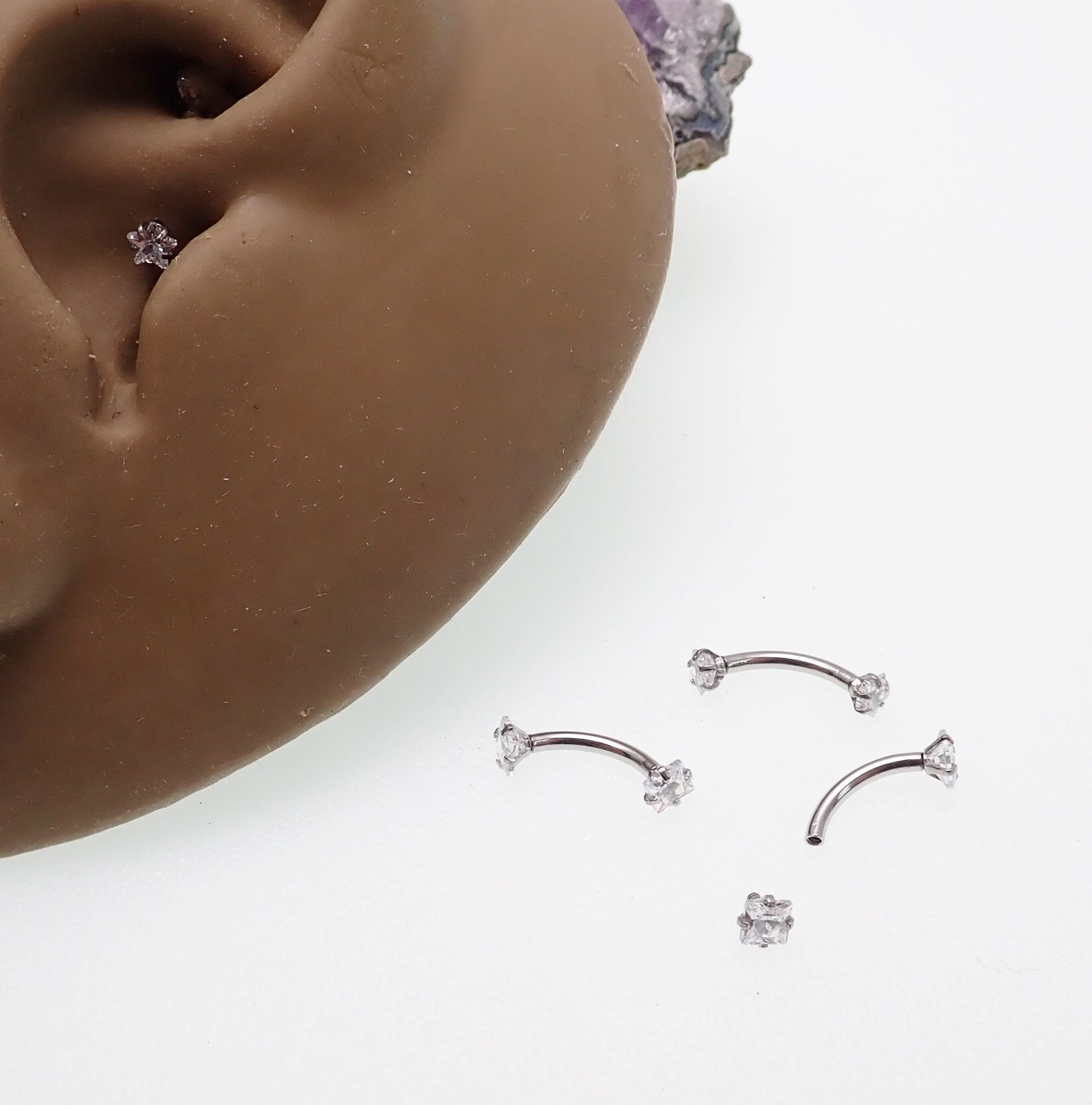 Star and square crystal steel body jewelry by Body Clickers, curved 16g body piercing with sparkling gemstones.