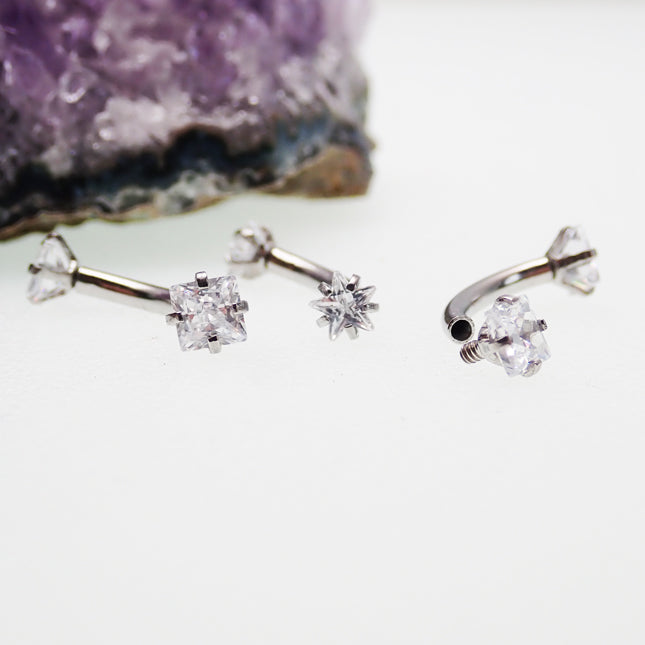 Star and square crystal steel body jewelry by Body Clickers, curved 16g body piercing with shiny star and square accents.