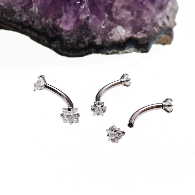 Sterling steel curved body jewelry with star and square crystal accents, 16g size, from Body Clickers.