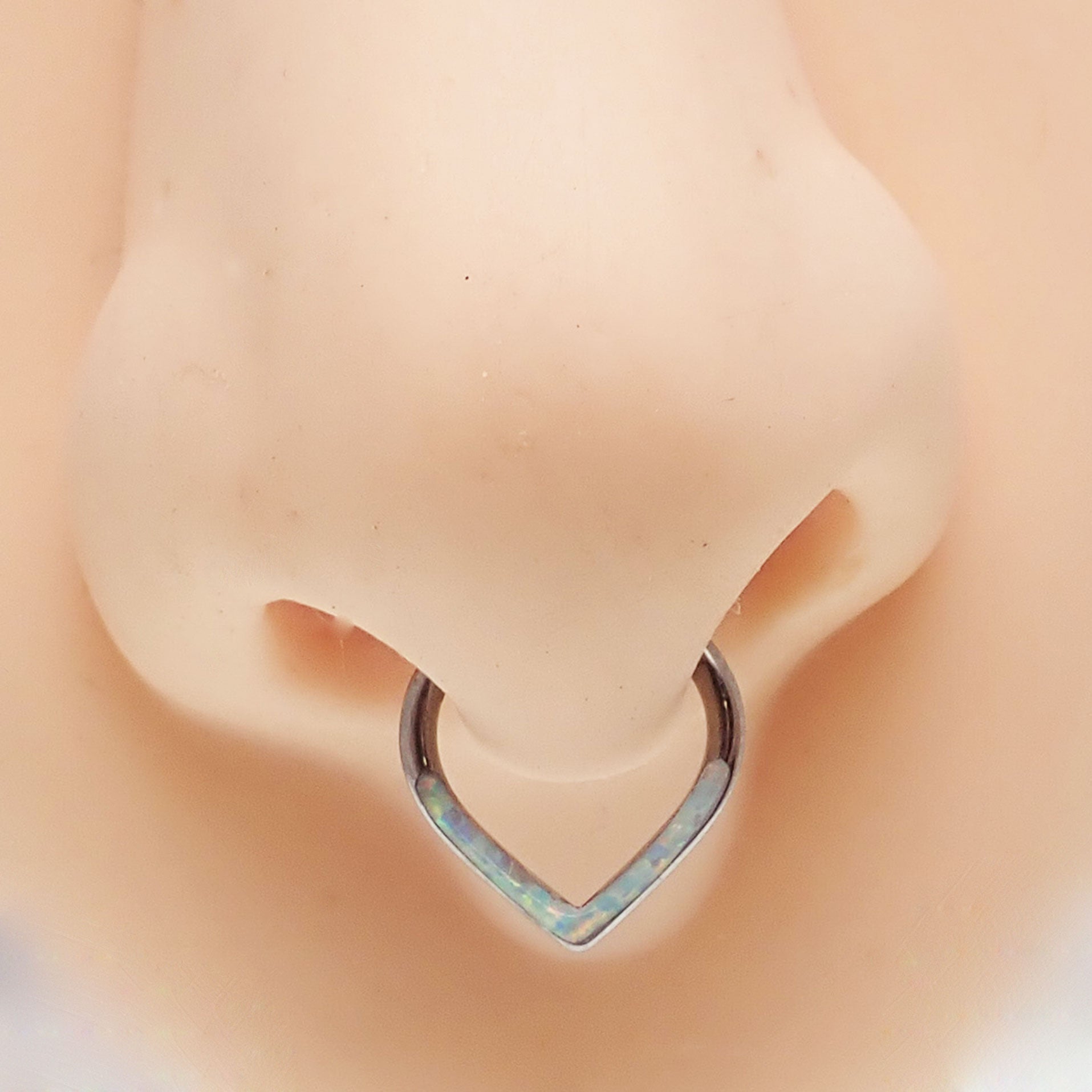Opal titanium heart-shaped clicker body jewelry in 16g with white accents, designed for ear or nose piercing.