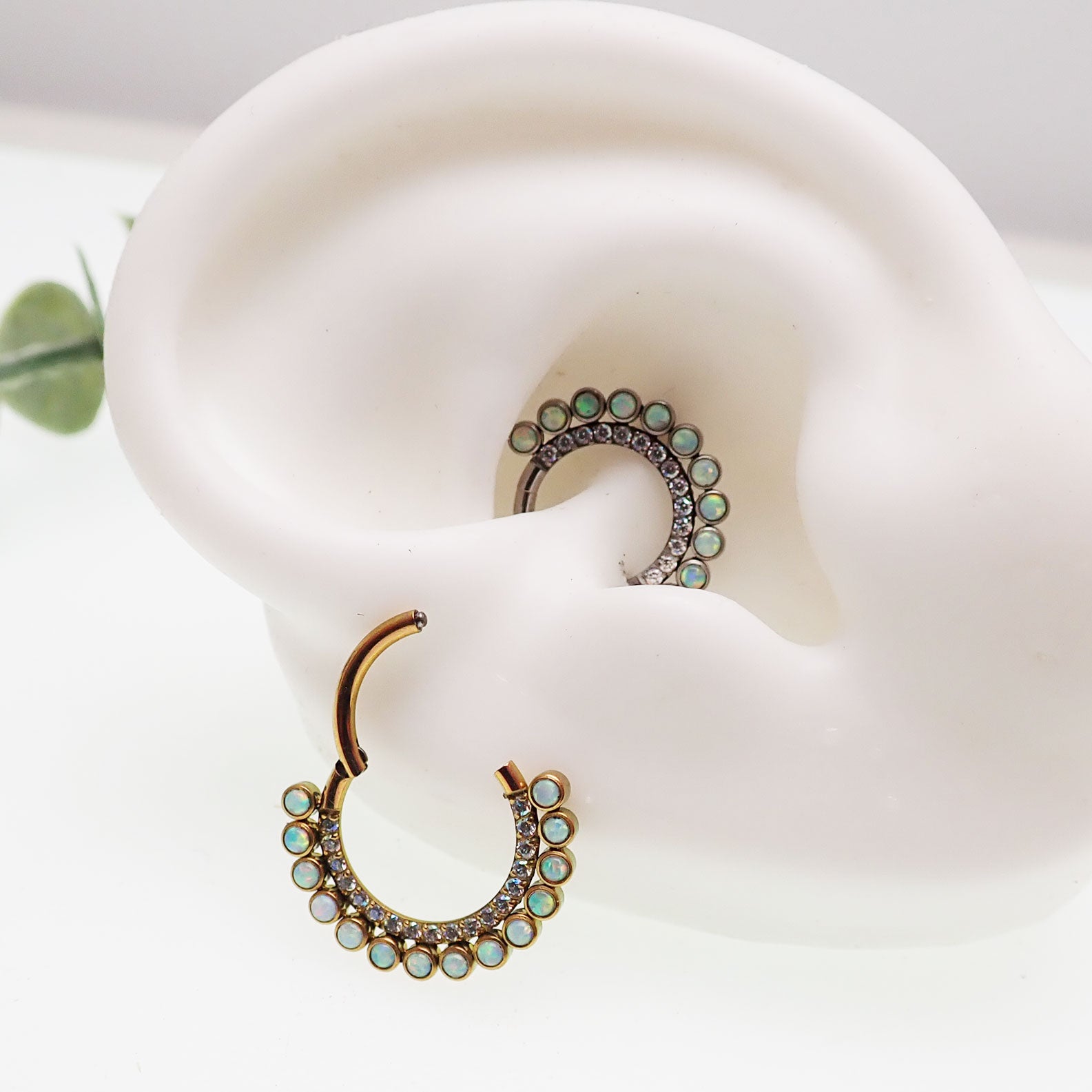 White opal and AB titanium 16g clicker earring by Body Clickers, featuring an 8mm decorative design on a clicker body.