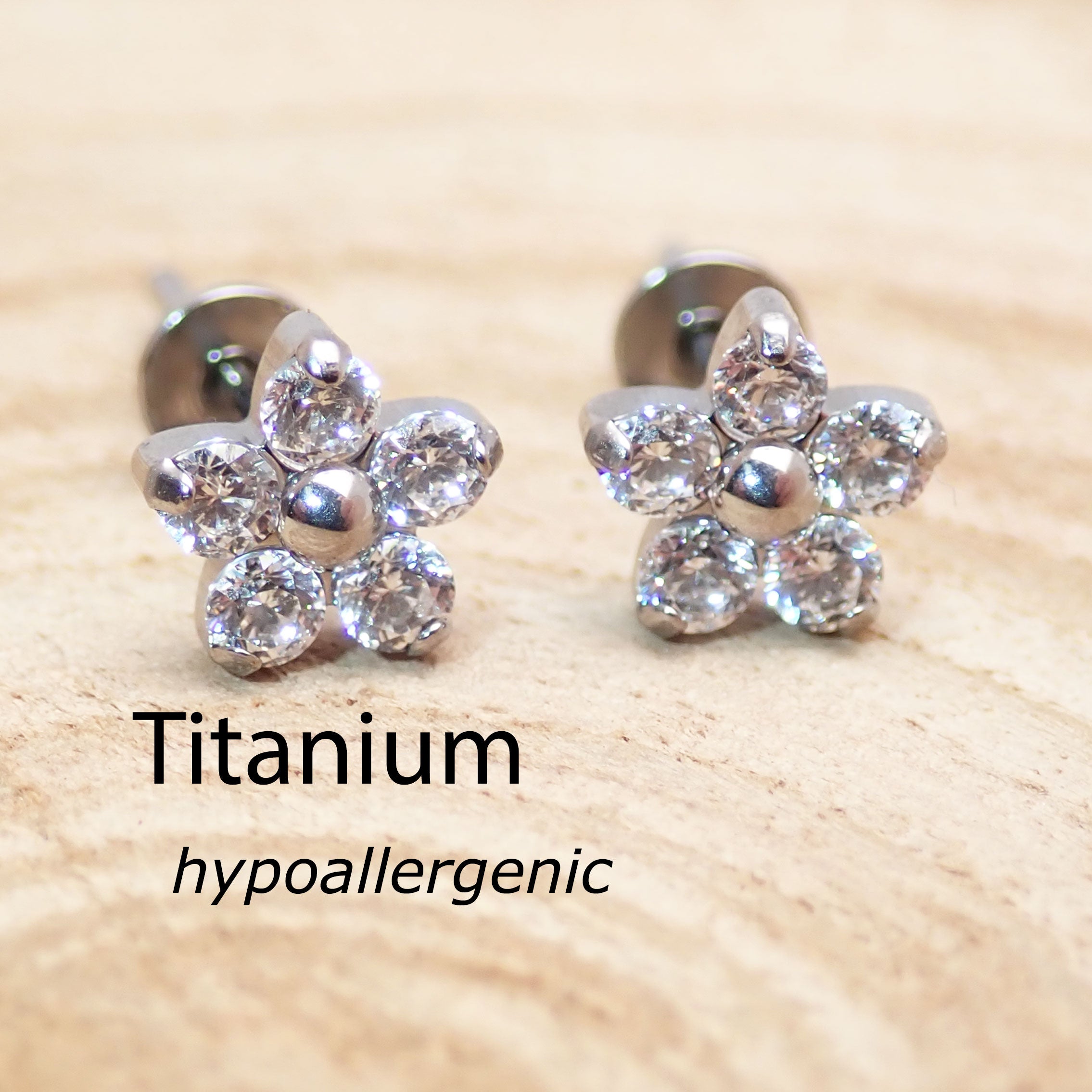 Titanium clear CZ flower earrings by Body Clickers, 20g implant jewelry with floral design and sparkling stones.