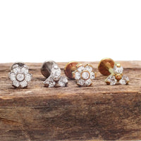 Two-piece set of clear CZ Trinity and flower titanium flatback earrings in 14g, 16g, and 18g for body piercing.