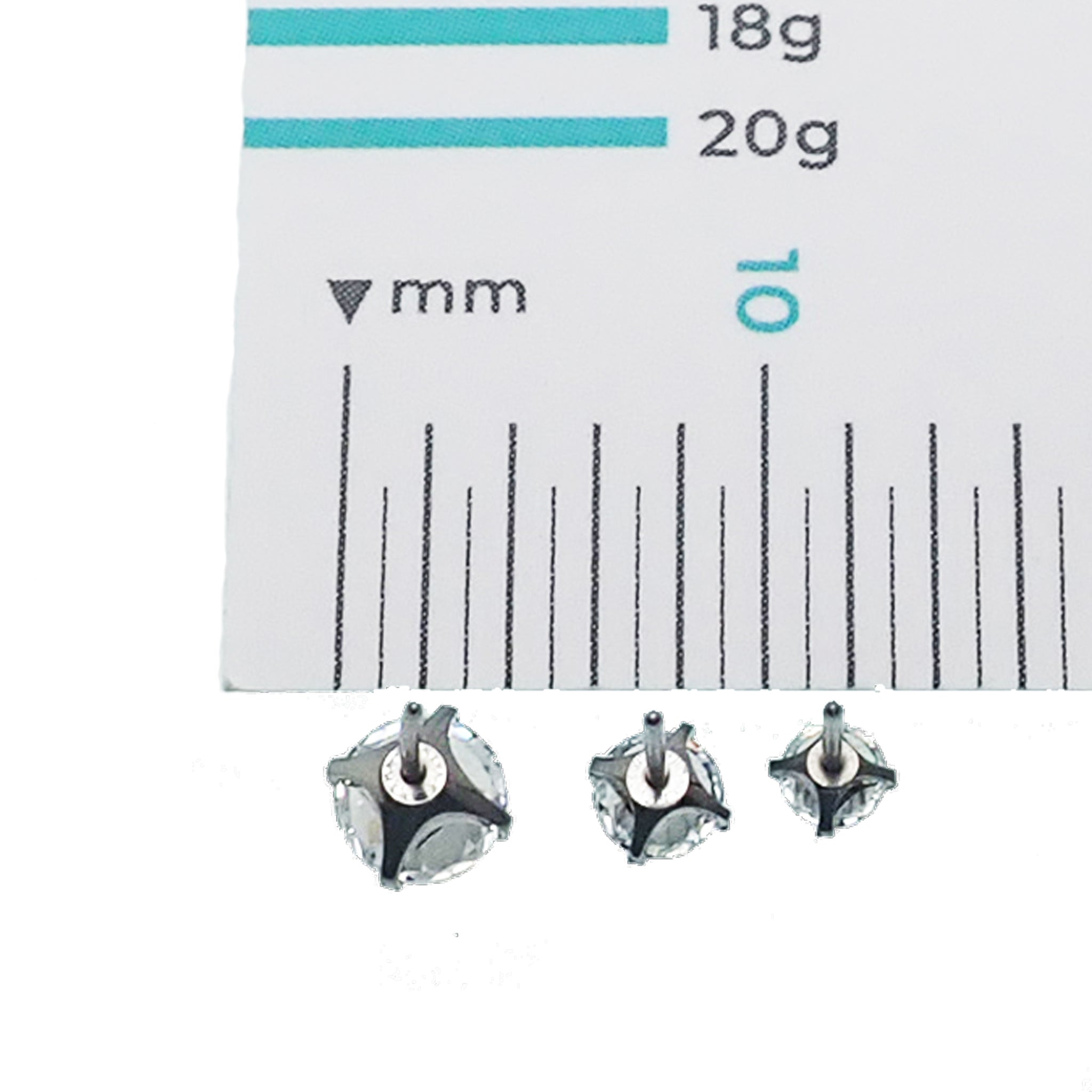 Pair of clear CZ crystal push-fit titanium earrings in 14g to 20g, featuring small 2.5mm gemstones and modern design.