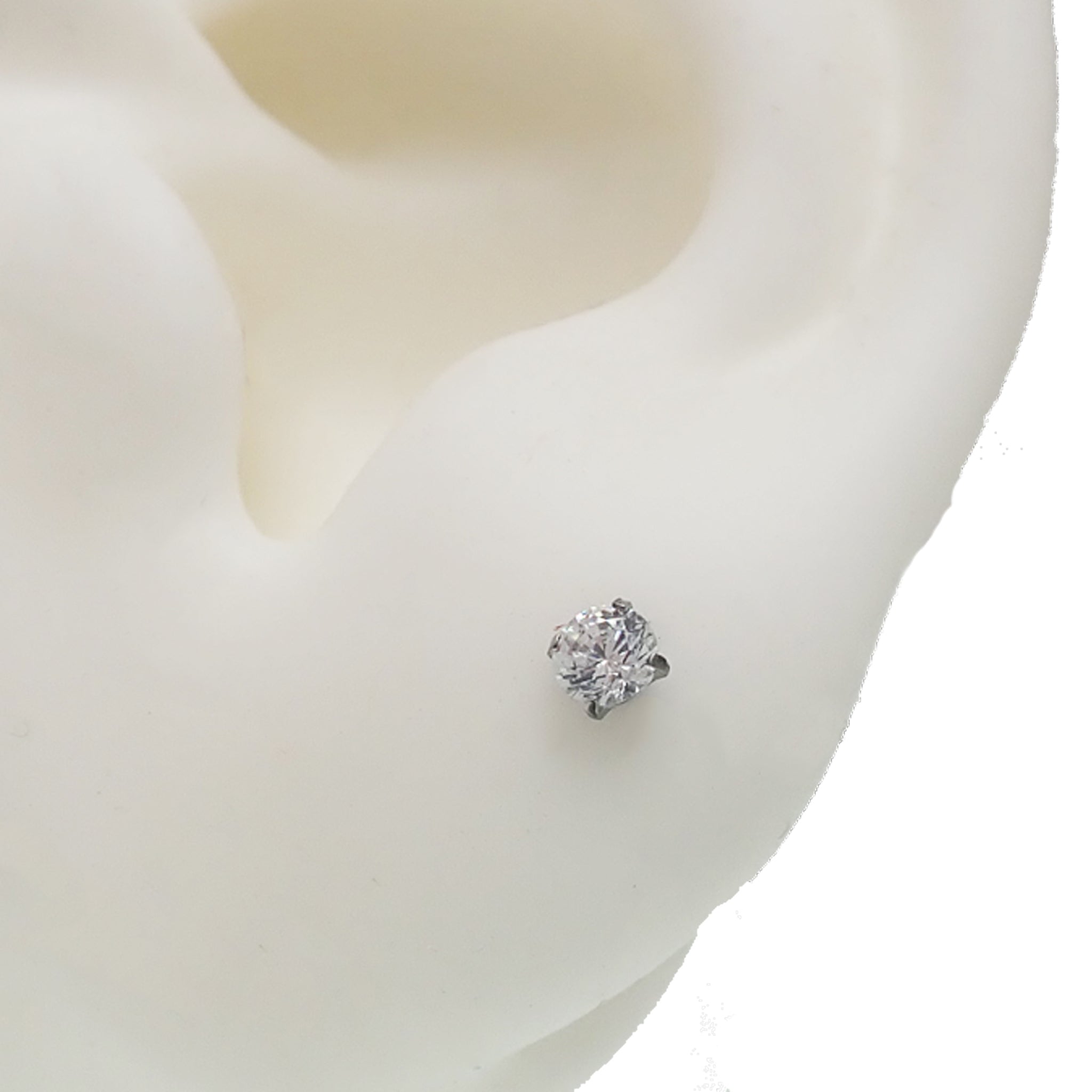 Pair of clear CZ crystal push fit titanium earrings in 14g to 20g, featuring small gemstone accents and sleek design.