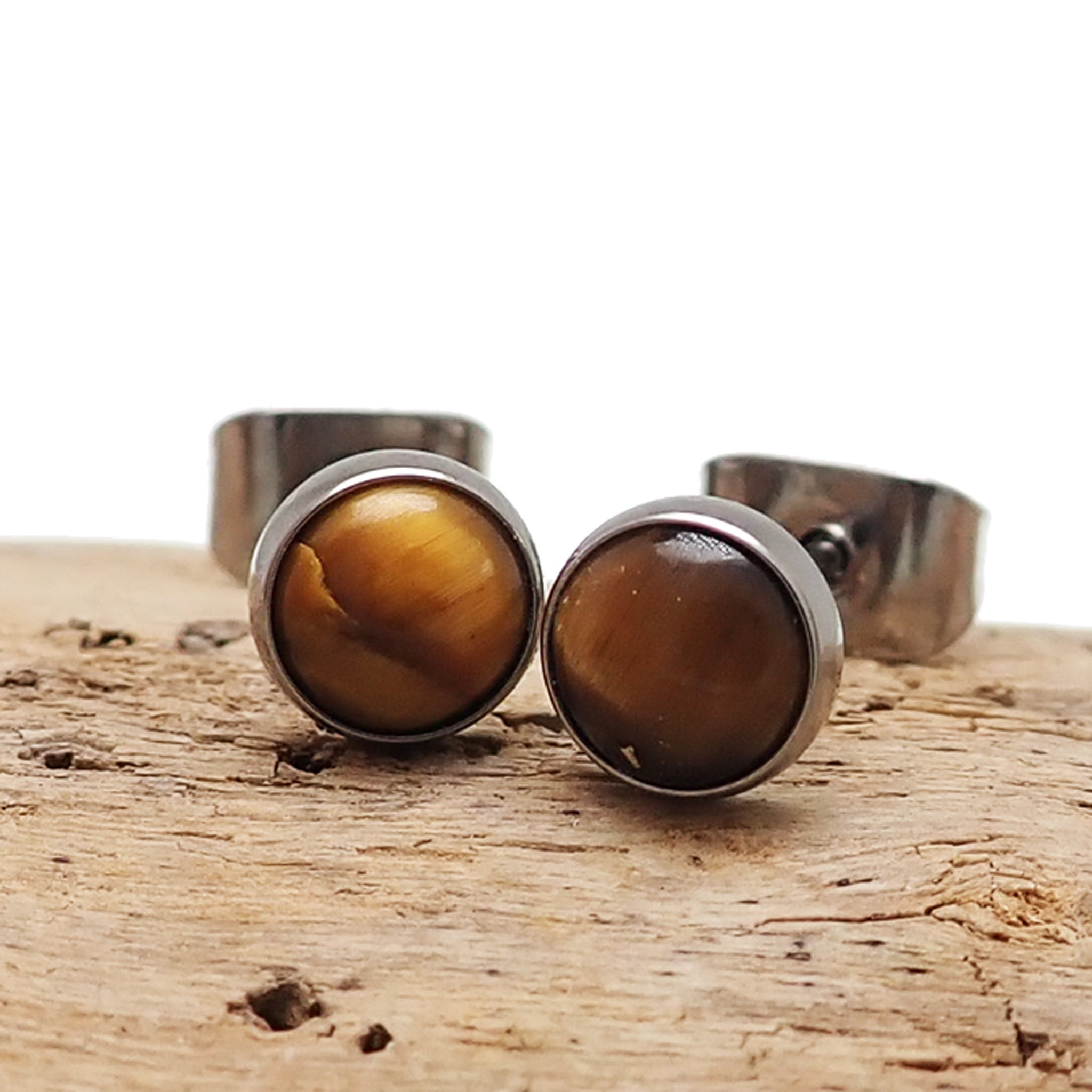 Pair of Tiger's Eye titanium earrings from Body Clickers, featuring smooth oval stones and sleek metal hooks.