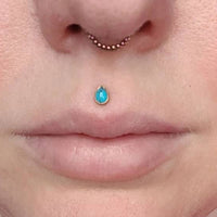 Titanium flat back labret with natural onyx stone in a tear drop shape, 18G 1.0mm, from Body Clickers.