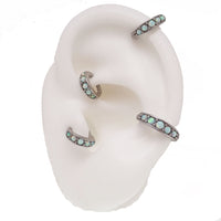 Surgical steel hinged clicker with opal beadwork for ear piercings, featuring a 6mm diameter, by Body Clickers.