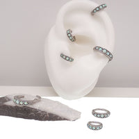 Hinged surgical steel clicker with opal beadwork, featuring a 6mm opal bead design for ear or body piercing jewelry.