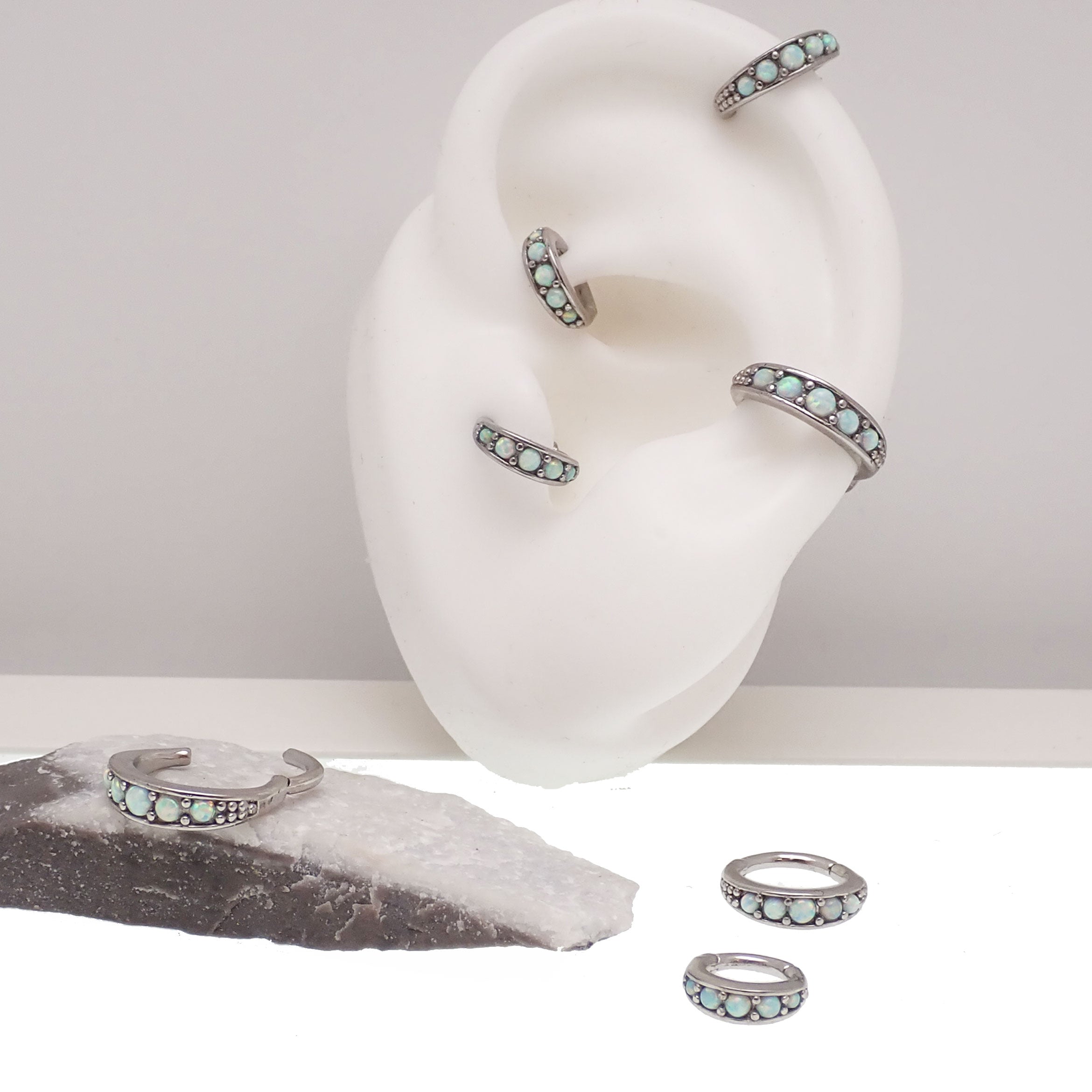 Hinged surgical steel clicker with opal beadwork, featuring a 6mm opal bead design for ear or body piercing jewelry.