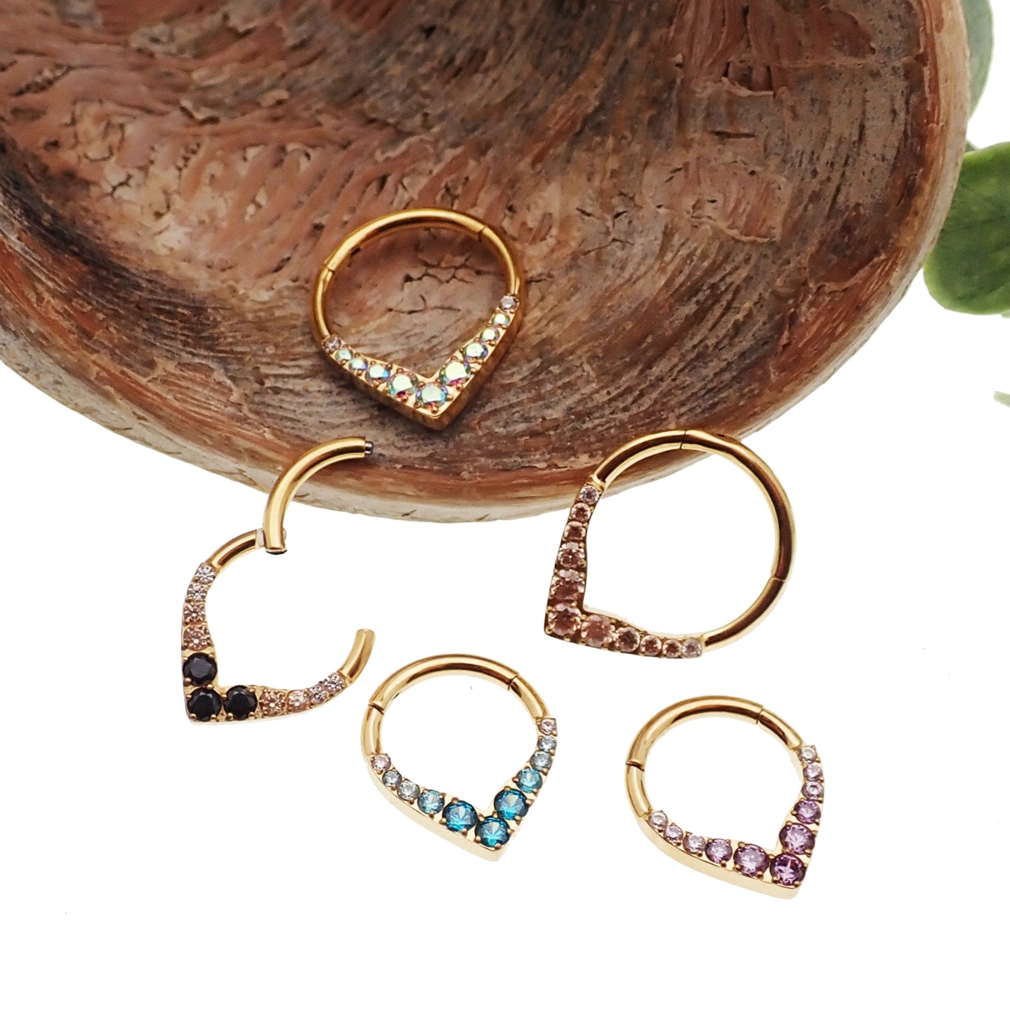 Gold titanium hinged clicker earring with CZ embellishments, designed for septum or daith piercings, by Body Clickers.