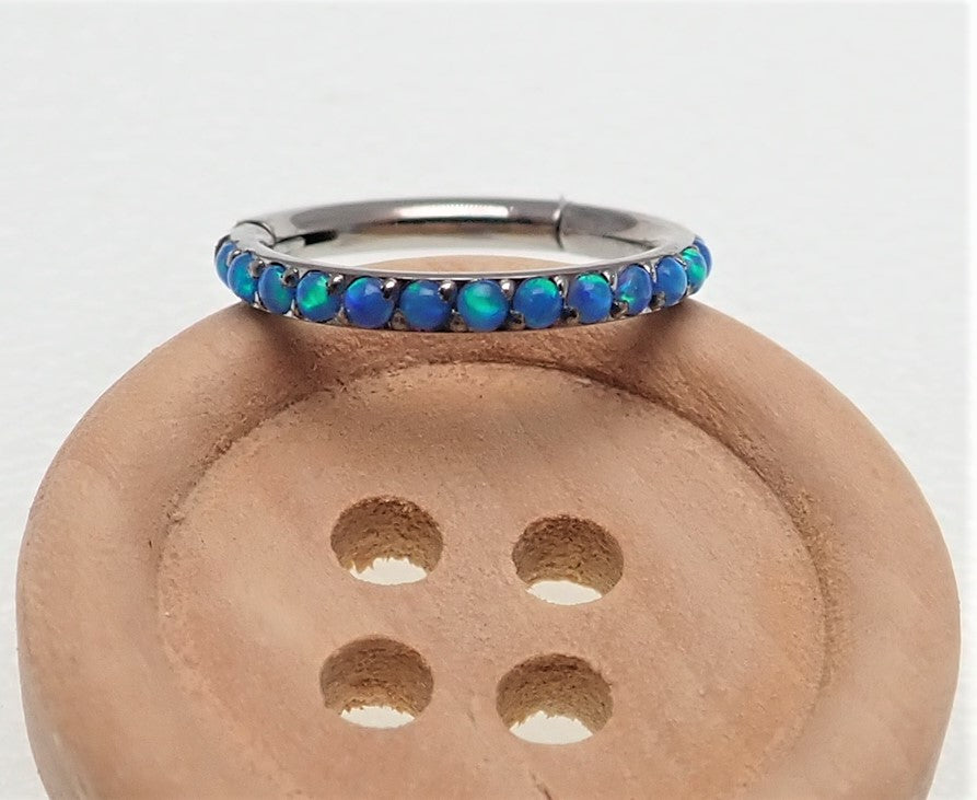 Hinged blue opal inlaid 6mm clicker earring by Body Clickers, 16g, shown with open clasp and polished metal finish.