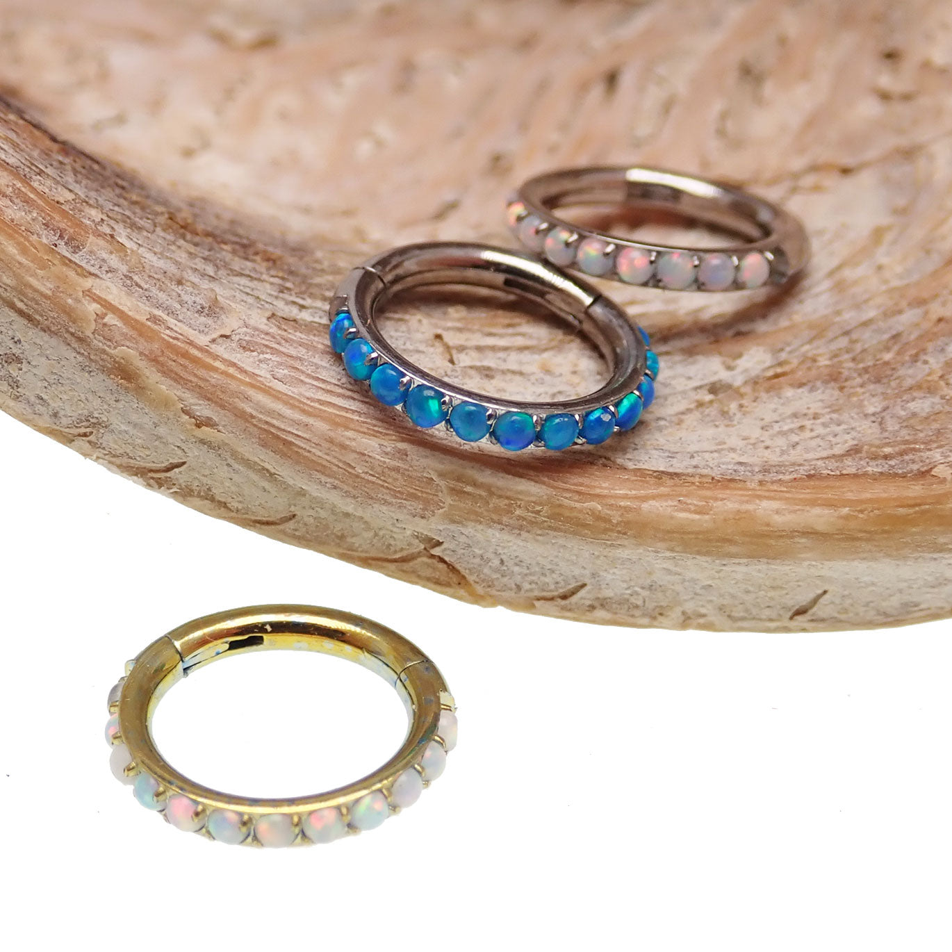 Blue opal inlaid 6mm hinged clicker earrings by Body Clickers, 16g body jewelry with a sleek design.