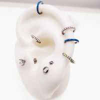 Blue opal inlaid 6mm hinged clicker earrings by Body Clickers, 16g, with a sleek, polished design for body piercing jewelry.
