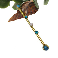 Turquoise and zircon titanium industrial piercing in 14g with a 32mm bar, featuring a sleek industrial jewelry design.