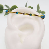 Turquoise and zircon titanium industrial piercing in 14g with a 32mm length, featuring a sleek industrial bar from Body Clickers.